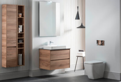 A modern bathroom featuring wooden fixtures, a sink, a mirror, and a toilet.