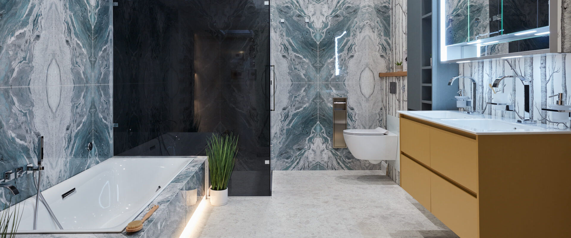 Modern bathroom featuring marble walls, a freestanding tub, shower, and minimalist cabinetry.