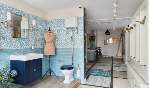 A stylish bathroom with patterned tiles, a sink, and a mannequin accentuating the decor.