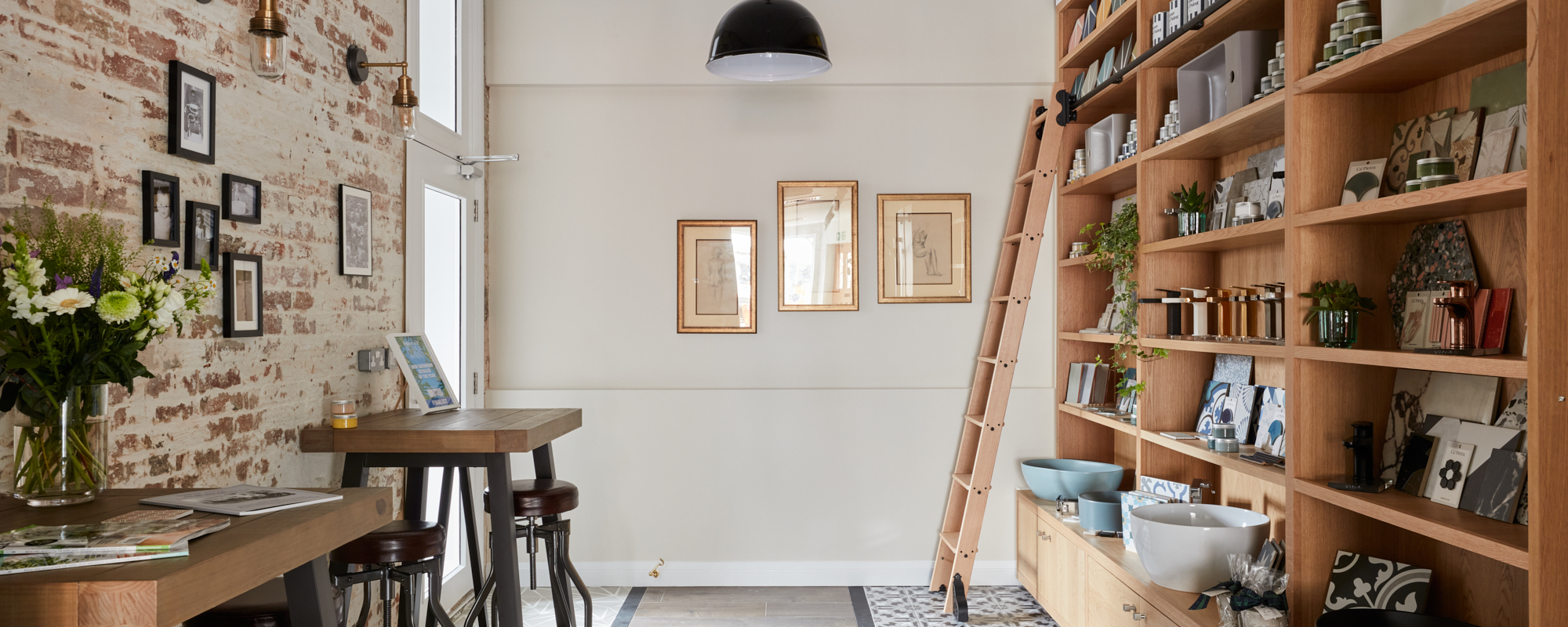A stylish interior featuring wooden furniture, shelves filled with items, and decorative lighting.