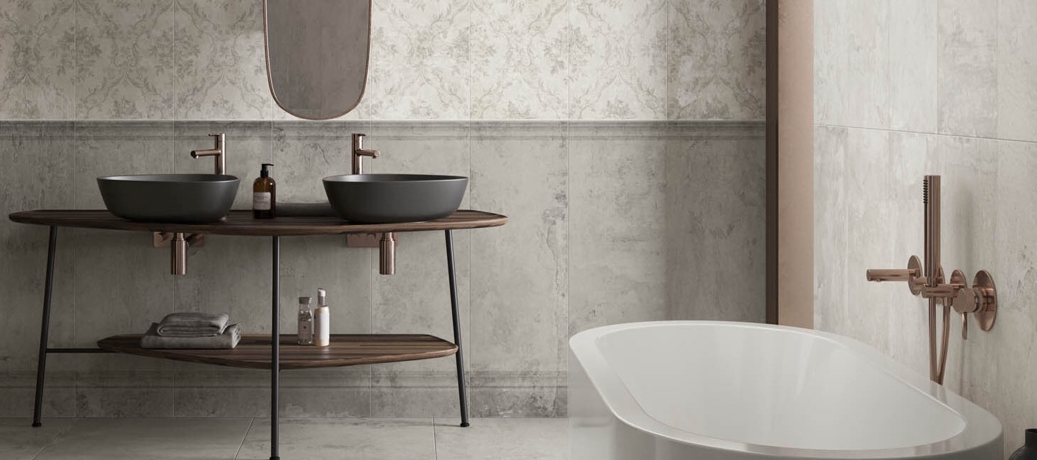 Bathroom with two black sinks, wooden counter, patterned tiles, and a freestanding bathtub.