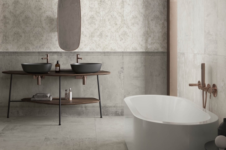 Bathroom with two black sinks, wooden counter, patterned tiles, and a freestanding bathtub.