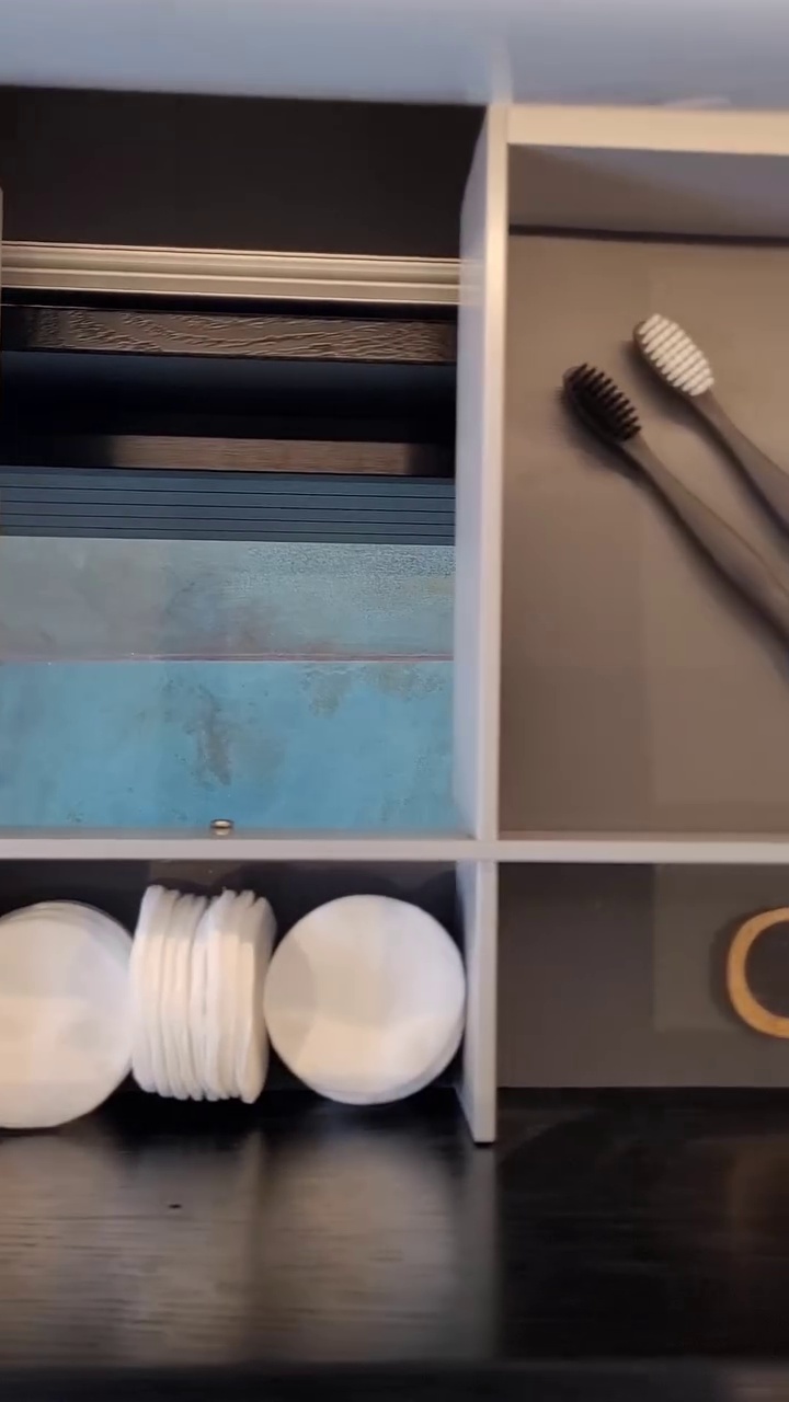 Metal grooved drawer unit supporting a white washbasin, complemented by an elegant chrome industrial faucet