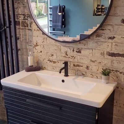Modern bathroom setup featuring a white sink and matte black industrial fixtures with clean, minimalist lines