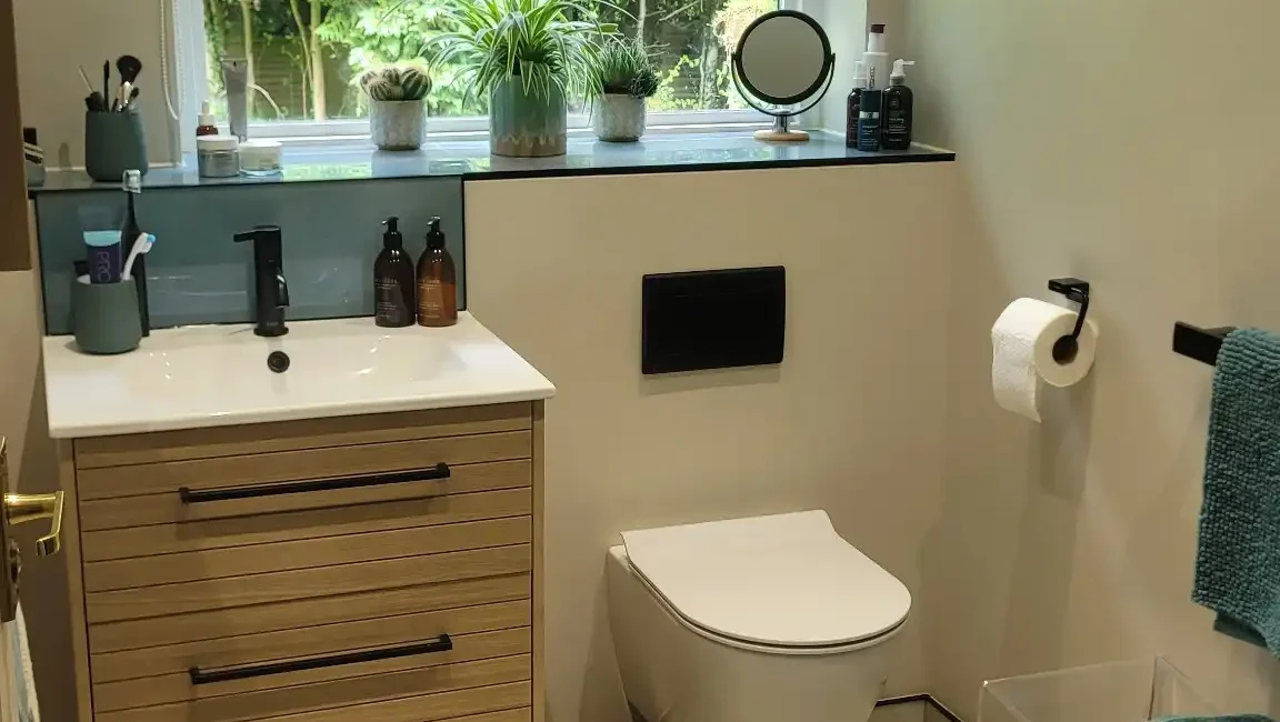 Stylish bathroom with wall-hung toilet and large window.