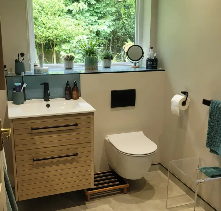 Stylish bathroom with wall-hung toilet and large window.