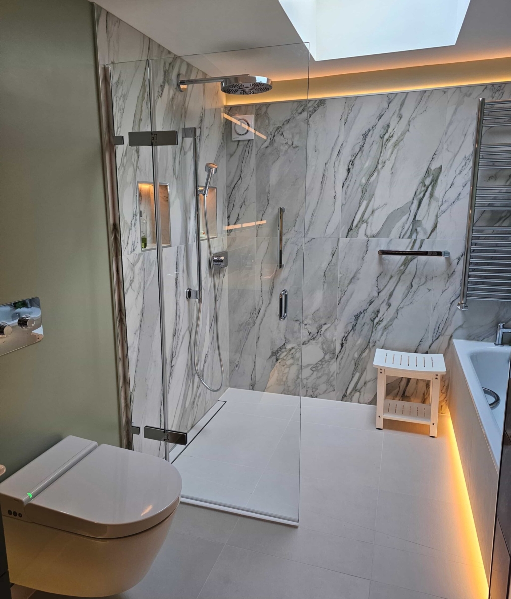 A contemporary wetroom featuring a tiled design with a bath opposite the shower and elegant LED lighting.