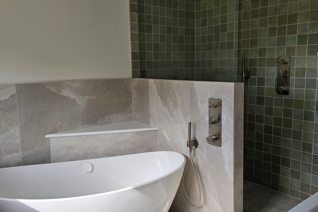 Calm modern bathroom with freestanding bath, wall-hung basin and textured wall tiles