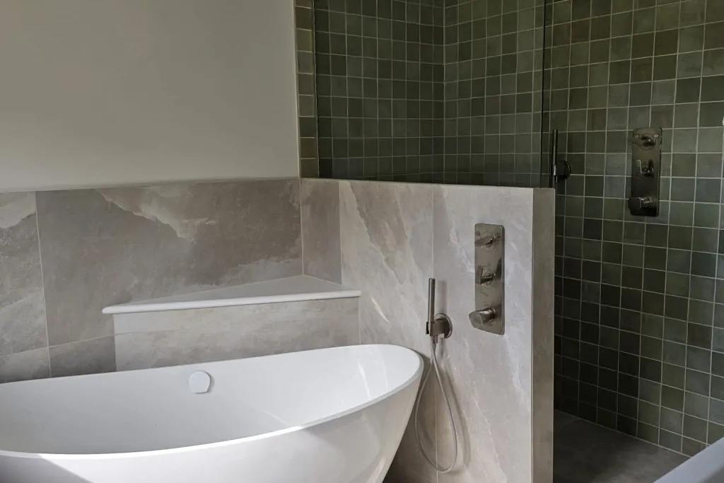 Calm modern bathroom with freestanding bath, wall-hung basin and textured wall tiles