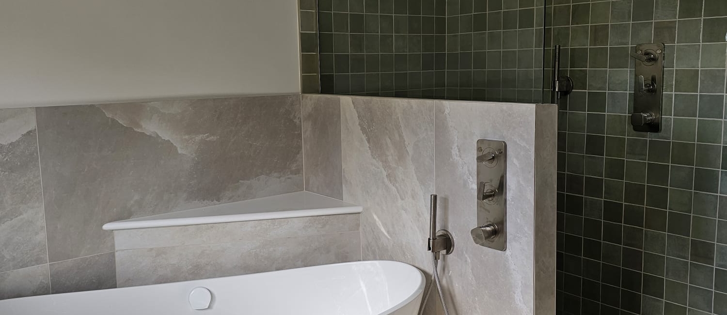 Calm modern bathroom with freestanding bath, wall-hung basin and textured wall tiles