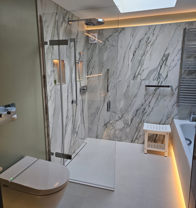 Accessible wet room with walk-in shower, marble-effect wall tiles and skylight