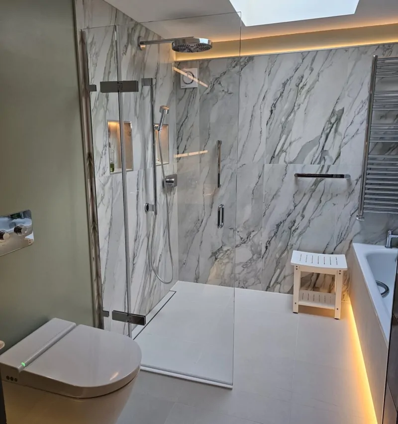 Accessible wet room with walk-in shower, marble-effect wall tiles and skylight