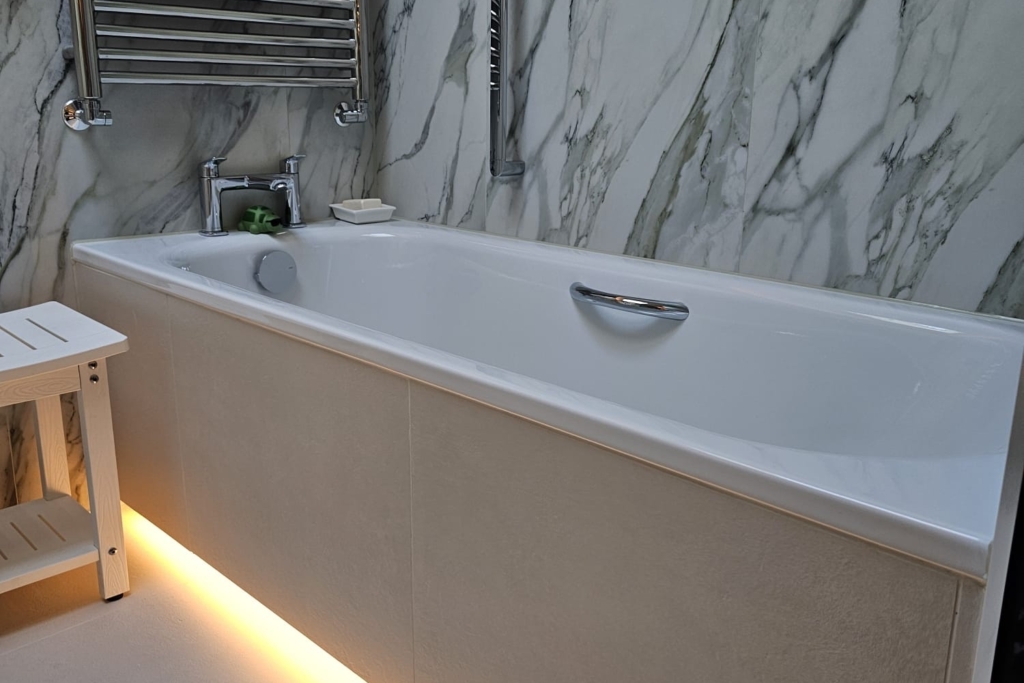 Wall-hung vanity unit with basin and warm under-cabinet lighting
