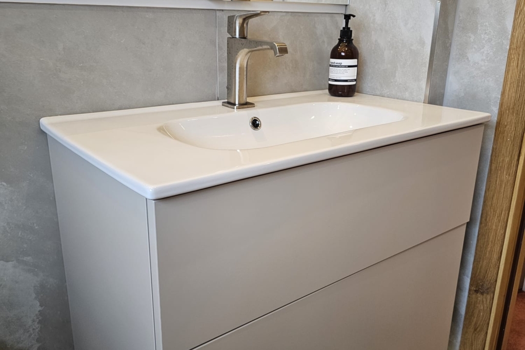 Grey wall-hung vanity unit with white basin and chrome tap