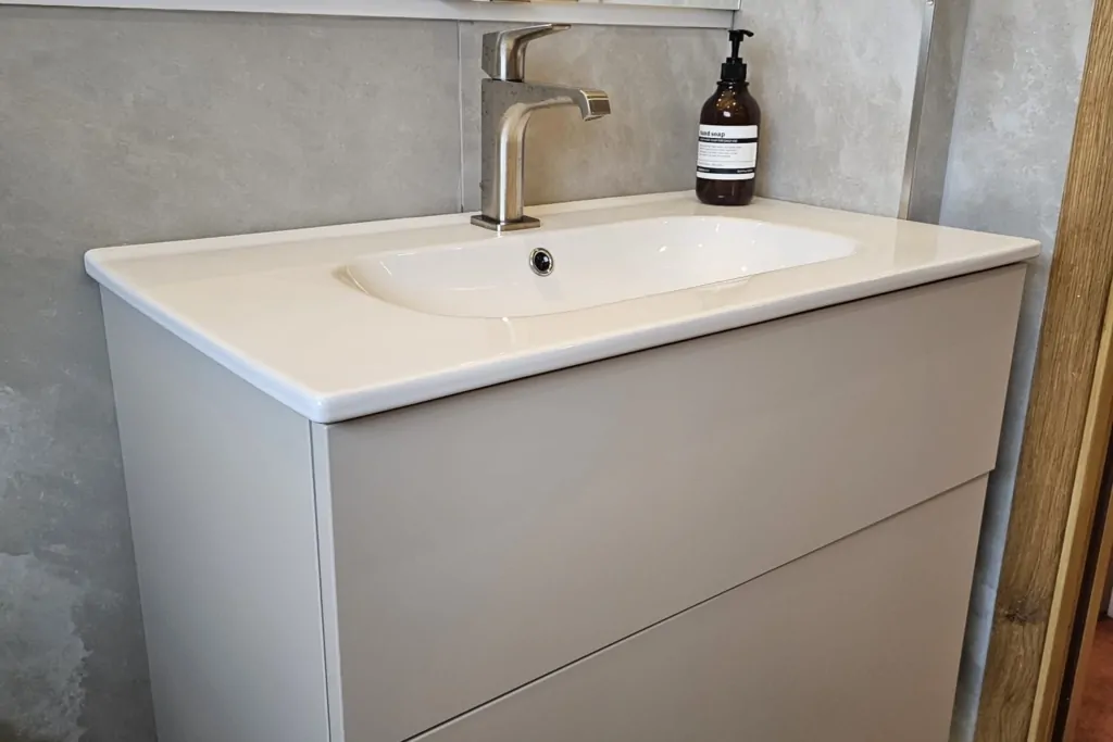 Grey wall-hung vanity unit with white basin and chrome tap