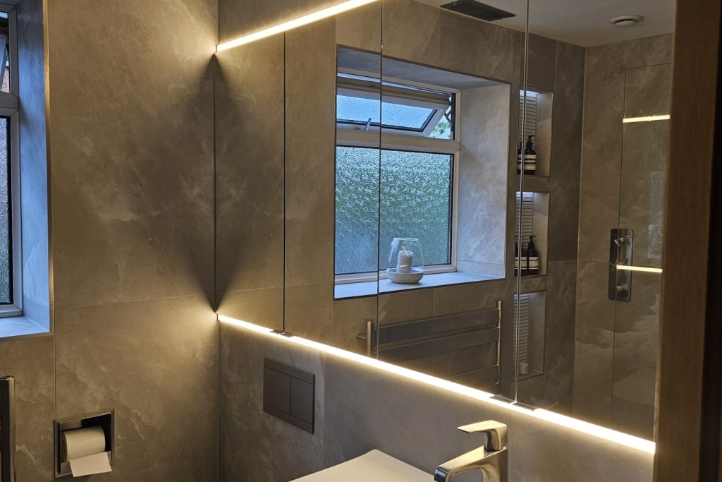 Modern bathroom vanity with basin and large illuminated wall mirror