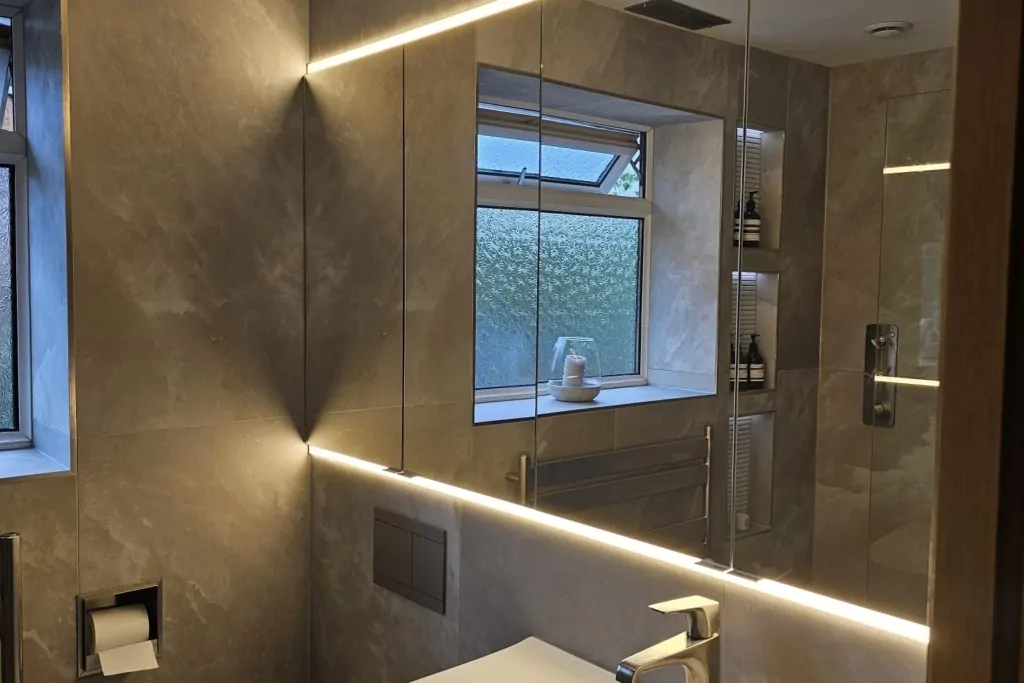 Modern bathroom vanity with basin and large illuminated wall mirror